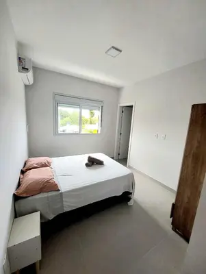 Uma cama ou camas num quarto em Apartamento Bosque das Oliveiras - Palmas
