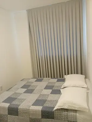 Uma cama ou camas num quarto em Apartamento na Praia de Itapema
