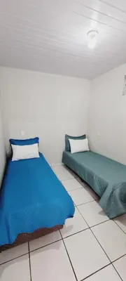 Uma cama ou camas num quarto em Hospedagem Reis e Japonês