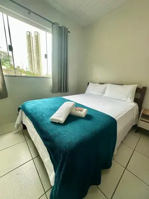 Uma cama ou camas num quarto em Hospedagem Reis e Japonês