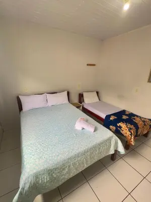 Uma cama ou camas num quarto em Hospedagem Reis e Japonês
