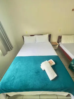 Uma cama ou camas num quarto em Hospedagem Reis e Japonês