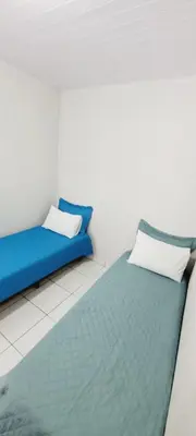 Uma cama ou camas num quarto em Hospedagem Reis e Japonês