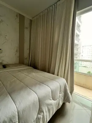 Uma cama ou camas num quarto em Itapema Sea Front Apartment
