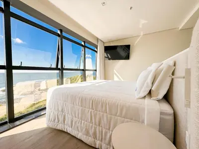Uma cama ou camas num quarto em Blue Sea Hotel Suite Luxo Frente Mar