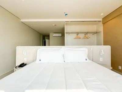 Uma cama ou camas num quarto em Blue Sea Hotel Suite Luxo Frente Mar