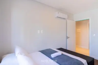 Uma cama ou camas num quarto em Apartamentos Completos a 700m da Praia - VNV