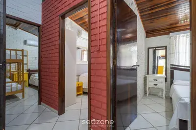 Uma cama ou camas num quarto em Linda casa a 230m da praia de Bombas RGV115