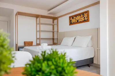 Uma cama ou camas num quarto em Pousada Nalu Bombinhas