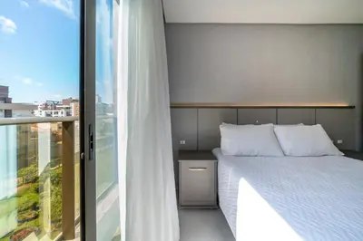 Uma cama ou camas num quarto em Sunrise Residence - Apto 2 dormitórios Praia de Bombinhas - Centro