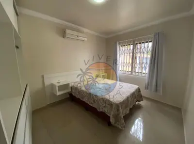 Uma cama ou camas num quarto em Apartamento no Centro de Bombinhas Próximo a Praia e Comércio em Geral