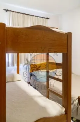 Uma cama ou camas num quarto em Apartamento na Avenida da Praia Zona Central ao Lado de Comércio em Geral com 02 Dormitórios