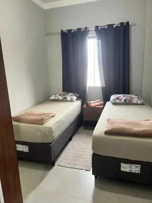 Uma cama ou camas num quarto em Casa em Tijucas da taty