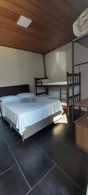 Uma cama ou camas num quarto em Suíte Varandas
