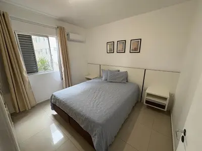 Uma cama ou camas num quarto em Apartamento Quadra Mar