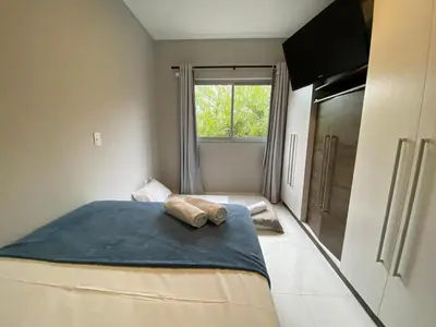 Uma cama ou camas num quarto em Apartamento em Bombinhas