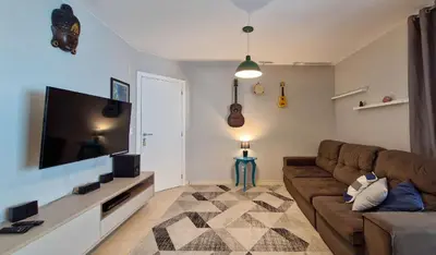Uma televisão e/ou sistema de entretenimento em Pé na Areia c/ Churrasqueira | 3 Quartos + Vaga