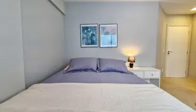 Uma cama ou camas num quarto em Pé na Areia c/ Churrasqueira | 3 Quartos + Vaga