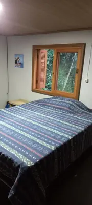 Uma cama ou camas num quarto em Casa do canto das ondas