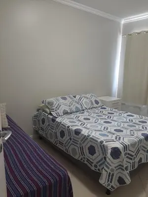 Uma cama ou camas num quarto em Apartamento 3 quartos em Bombinhas a apenas 100 metros da praia