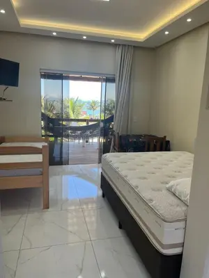 Uma cama ou camas num quarto em Loft Sol e Mar Exclusivo em Bombinhas 50m da praia