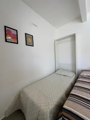 Uma cama ou camas num quarto em Apto térreo em Tijucas n 04