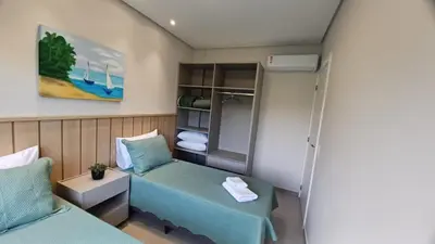 Uma cama ou camas num quarto em Apartamento na praia de Palmas em Governador Celso Ramos