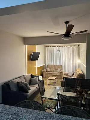 Uma área de estar em Apartamento com 03 dormitórios