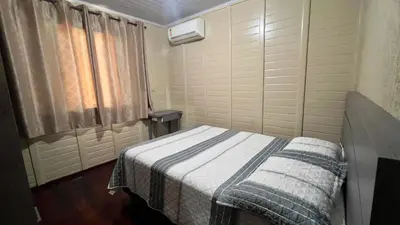 Uma cama ou camas num quarto em Recanto Silveira 150 metros da Praia Canto Grande Mar de Fora( Mariscal )