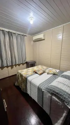 Uma cama ou camas num quarto em Recanto Silveira 150 metros da Praia Canto Grande Mar de Fora( Mariscal )