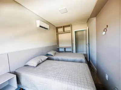 Uma cama ou camas num quarto em Praia de Palmas - 100m do Mar em Prédio Novo - 0188