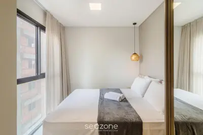 Uma cama ou camas num quarto em Sua estadia exclusiva a poucos passos do Mar em Meia Praia - FFS