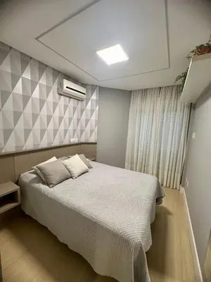 Uma cama ou camas num quarto em 128A - Boulevard Bombinhas – até 6 pessoas