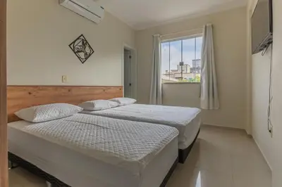 Uma cama ou camas num quarto em Apartamento Bombinhas próximo à praia