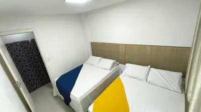 Uma cama ou camas num quarto em Linda Cobertura Bombinhas - perto PRAIA- AR Condicionado em todos ambientes Churrasqueira - Comporta 10 pessoas