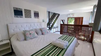 Uma cama ou camas num quarto em Pousada Palmeiras Bombinhas