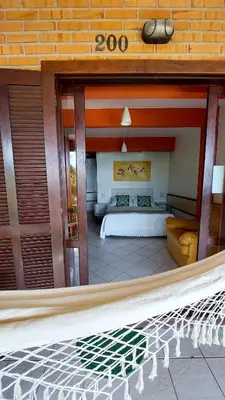 Uma cama ou camas num quarto em Pousada Palmeiras Bombinhas