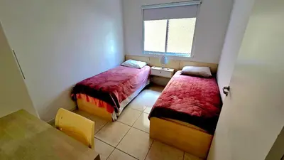 Uma cama ou camas num quarto em Jardim Cristal