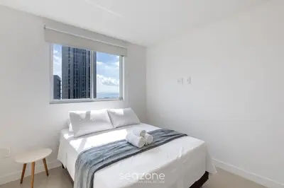 Uma cama ou camas num quarto em Apartamentos a 400m da Praia em Itapema - CARA