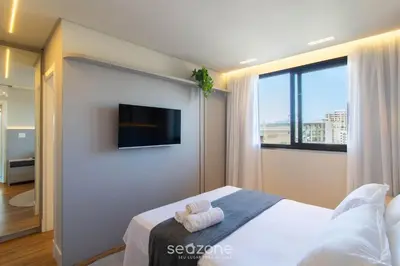 Uma cama ou camas num quarto em Apartamentos Bem Equipados a 100 m da Praia - EVR