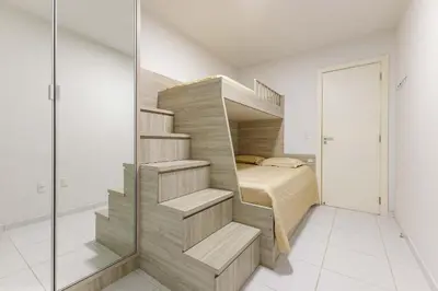 Uma cama ou camas num quarto em Amplo Apto a 50 Metros da Praia de Bombinhas