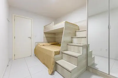 Uma cama ou camas num quarto em Amplo Apto a 50 Metros da Praia de Bombinhas