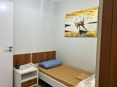 Uma cama ou camas num quarto em Clube do Mar- Itapema Meia Praia APTO 102 A