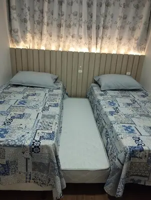 Uma cama ou camas num quarto em Ilumini Apartment