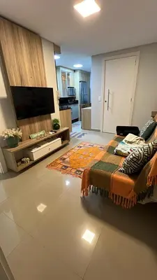 Uma televisão e/ou sistema de entretenimento em Apartamento aconchegante praia de palmas