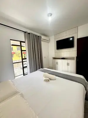 Uma cama ou camas num quarto em Casa no centro de bombinhas, SC