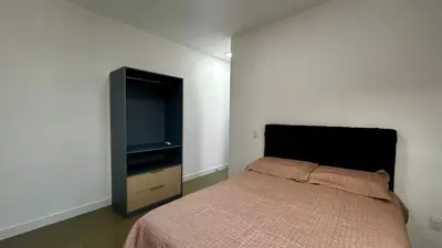 Uma cama ou camas num quarto em apto dapraia 401