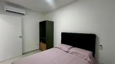 Uma cama ou camas num quarto em apartamento praia de Palmas angel 303