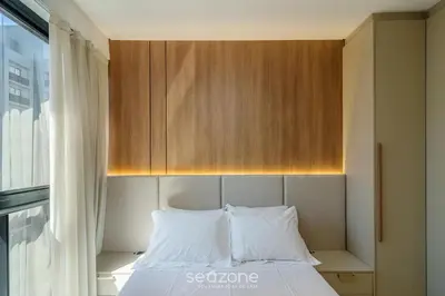 Uma cama ou camas num quarto em Aptos em prédio a 90 m da praia de Perequê - RIHs