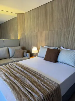 Uma cama ou camas num quarto em Novíssimo e charmoso studio em Palmas